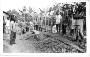 Ogoni villagers survey destroyed canoes at Kaa, 5th January 1994. Photograph by Sr. Majella McCarron. Maynooth University Ken Saro-Wiwa Archive.