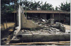 Destroyed buildings at Kaa Market in Ogoniland, 1994. Photograph by Mary Sweeney. Maynooth University Ken Saro-Wiwa Archive.