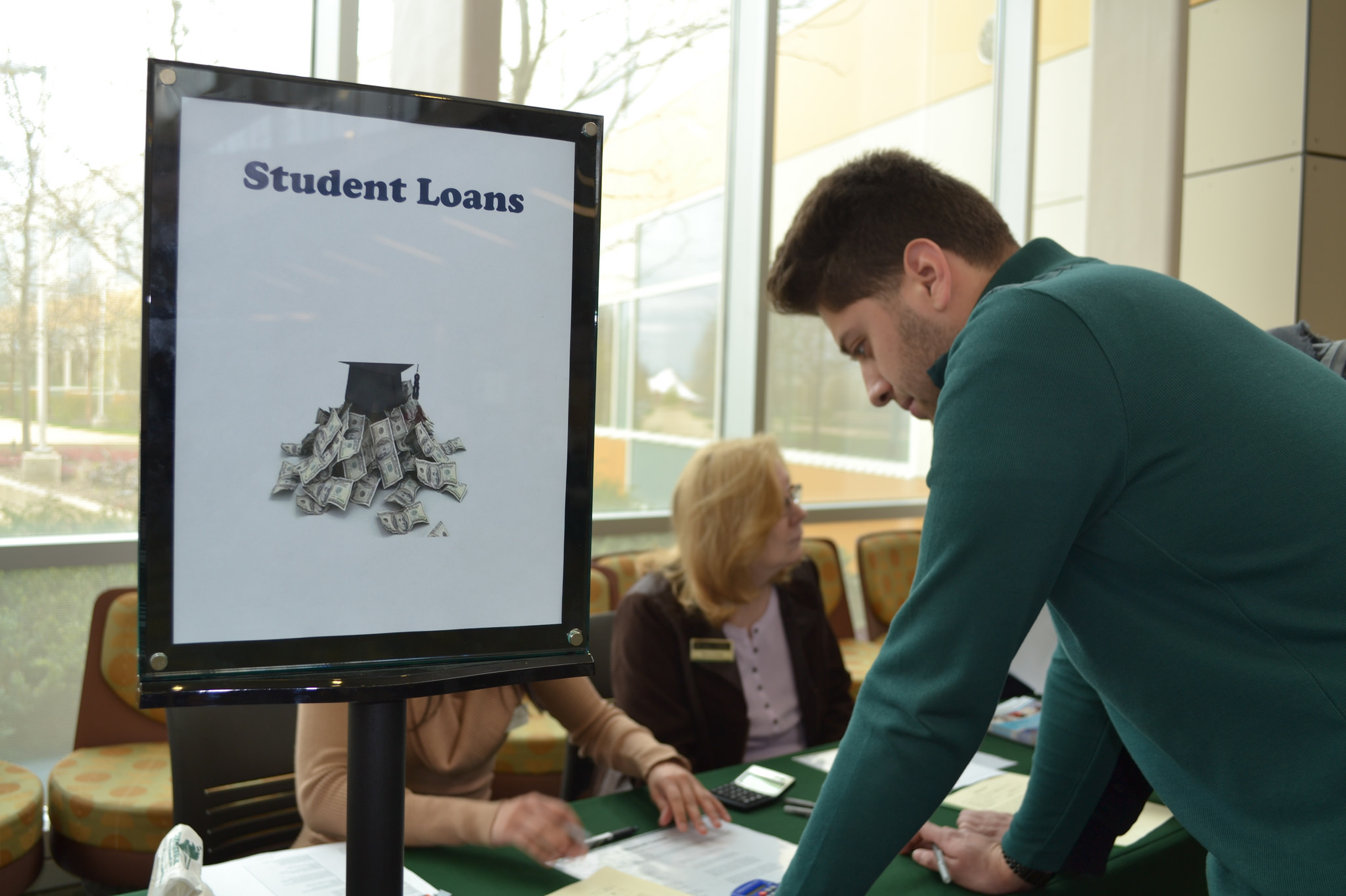 Image of man standing at a financial aid desk