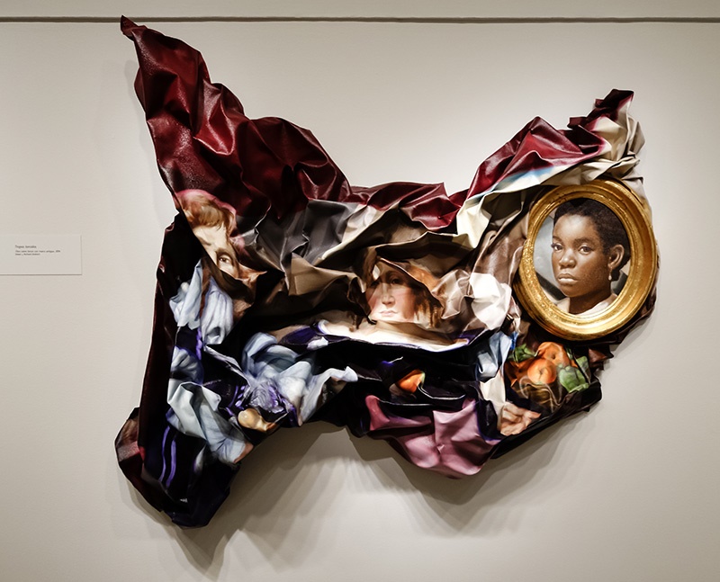 A photo shows the famous work “Twisted Tropes” by Titus Kaphar hanging on a wall.