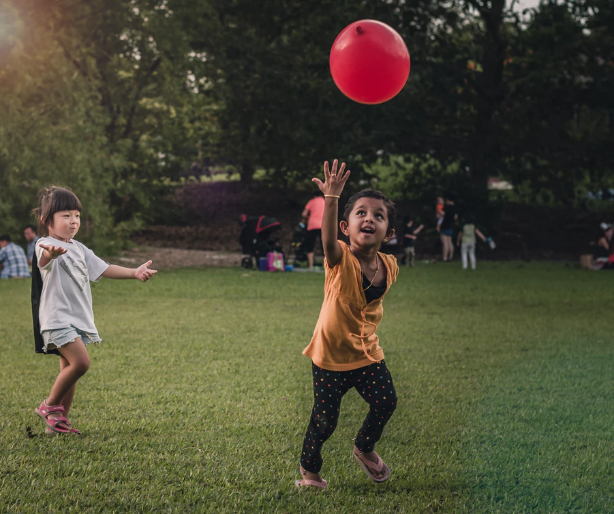 Picture of two children playing with a balloon