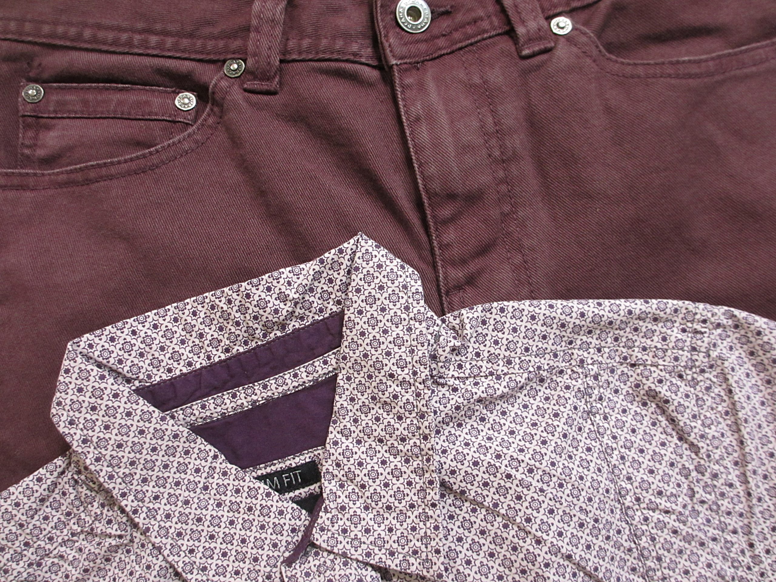 image of waistband of purple jeans and a button down shirt with a purple pattern.