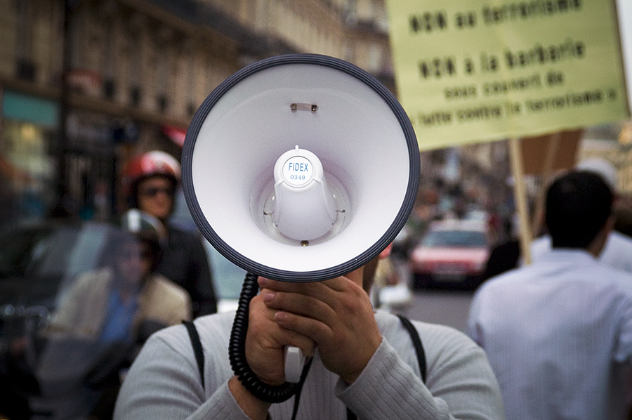 Man holding megaphone at protest