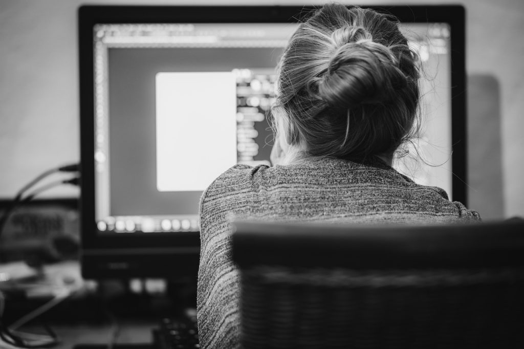 Woman working a desktop computer.