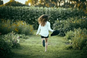 Child running through a garden