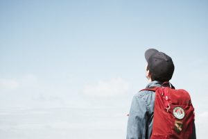 Man staring at white sky taken at daytime.