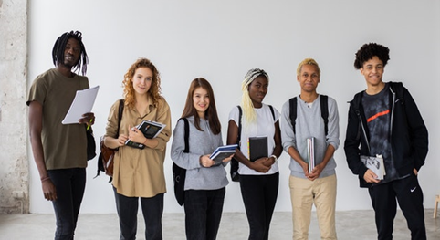 Group of multi-ethnic students with books and documents