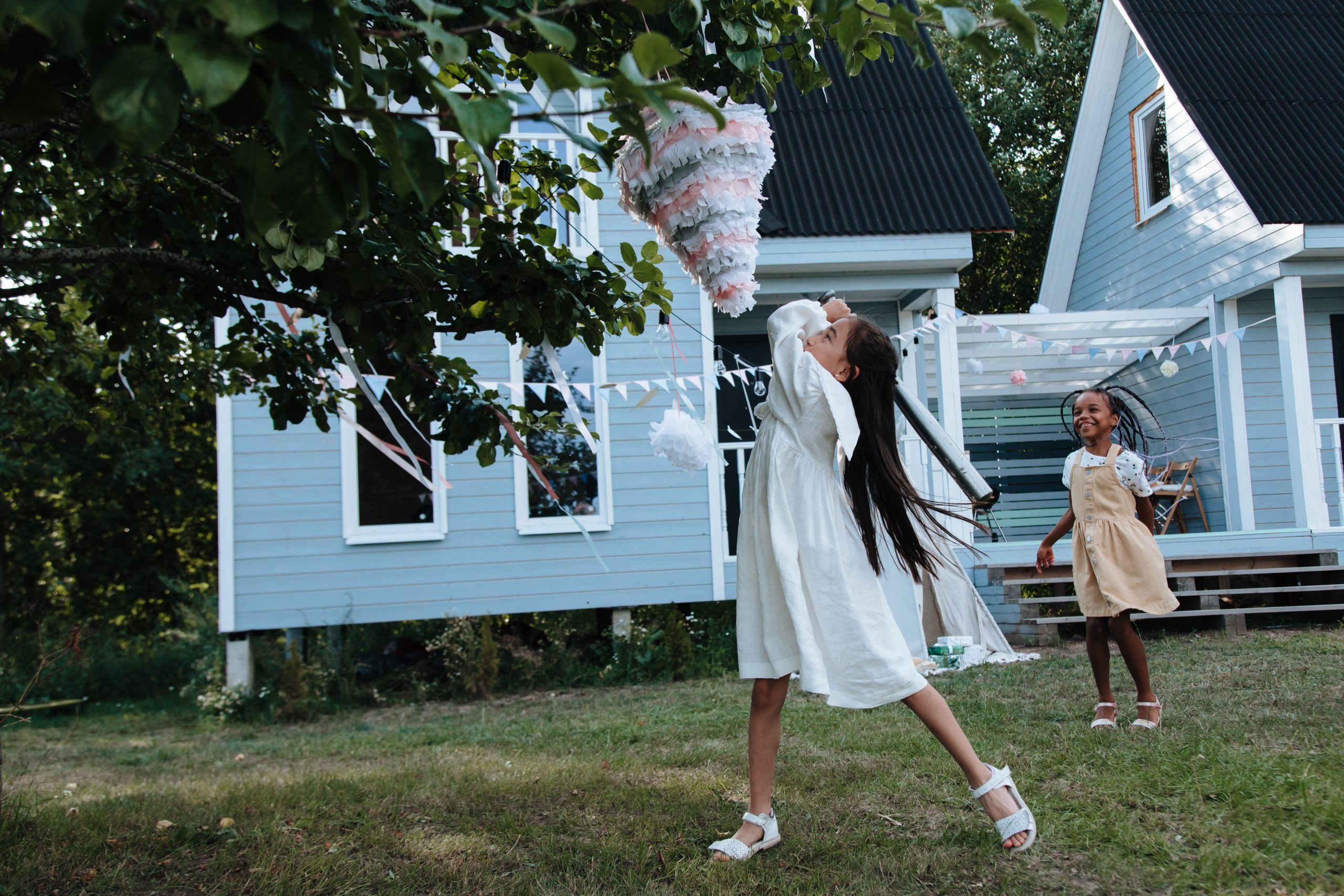 Young girl hitting pinata