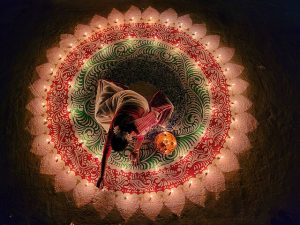 A woman lights candles during the festival of Devali