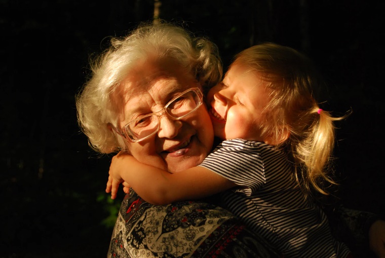 image of older woman hugging little girl