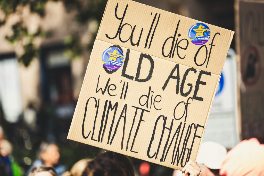 Protest sign that states "You'll die of old age. We'll die of climate change"