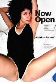 American Apparel Ad shows a young woman in a swimsuit lying down with her knees apart