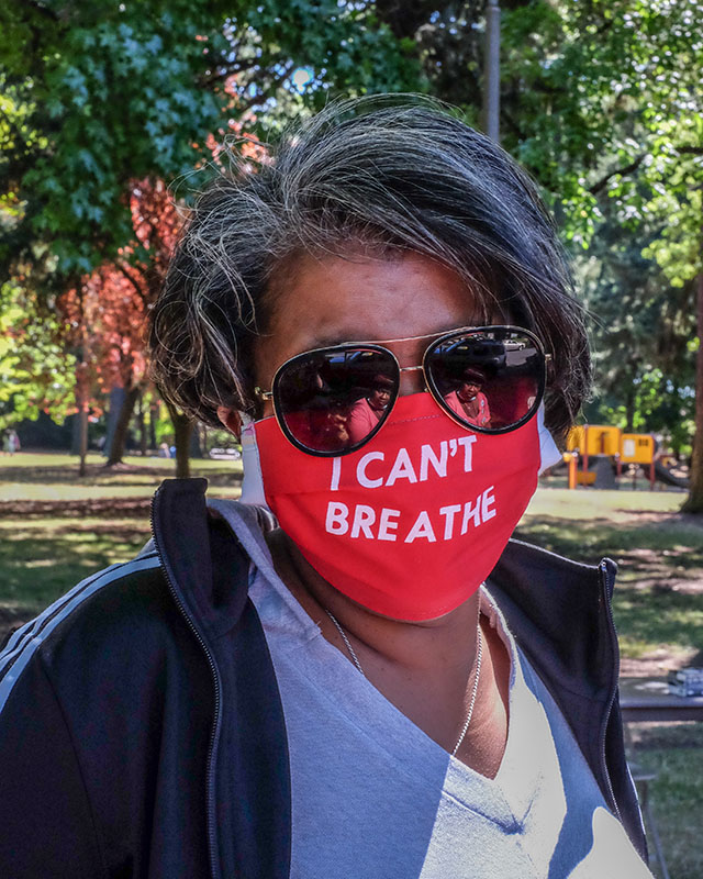 Person wearing a red mask that says "I Can't Breathe" in white letters