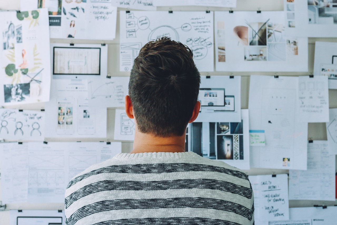 Man stares at wall of research