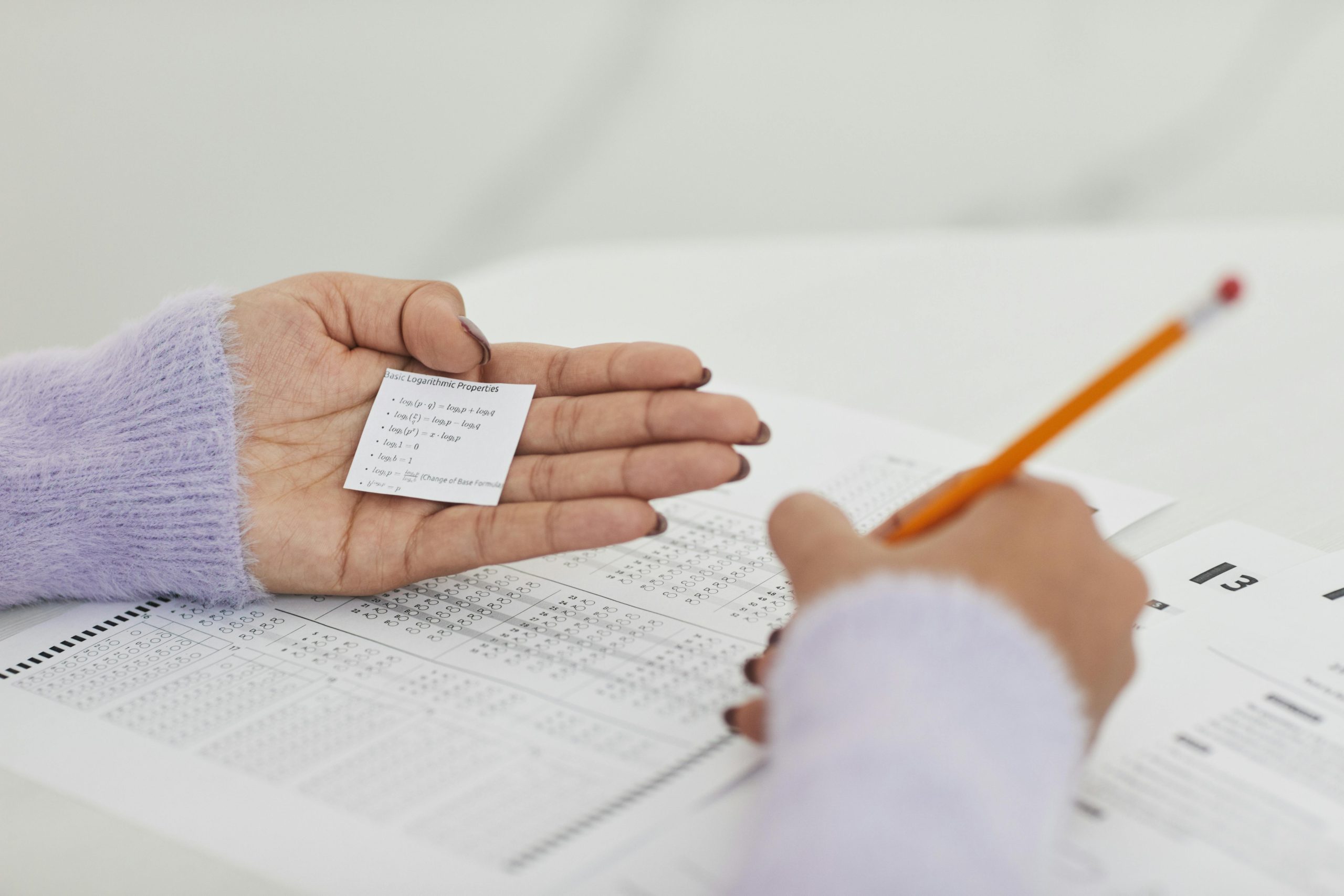 Student takes exam but has a small cheat sheet hidden in their hand