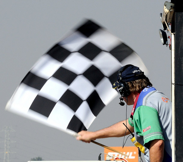 A man waving a checkered flag