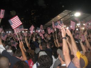 Crowd holding American flags