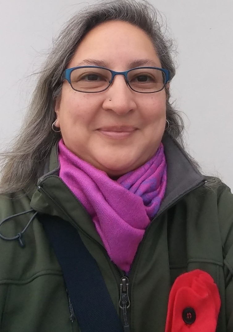 Woman with glasses and a purple scarf.