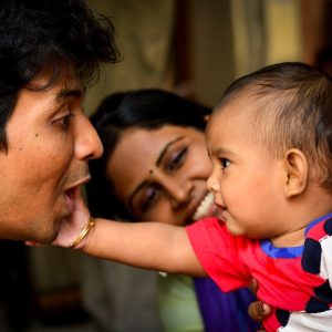 Baby touching a man's face