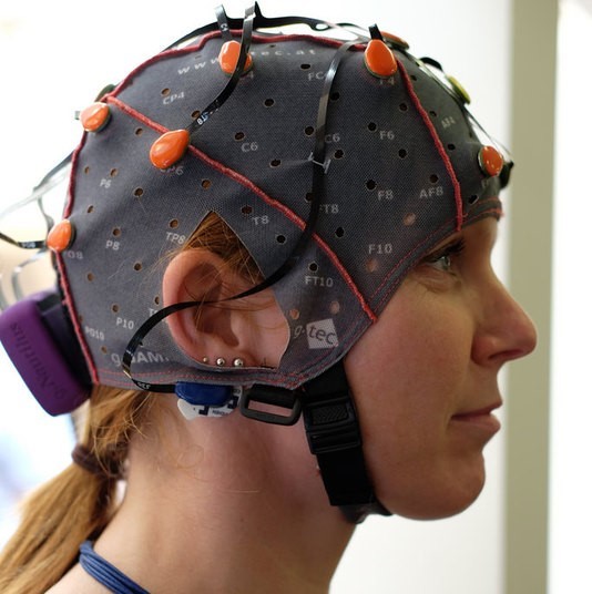 Photo of woman wearing a cap with wires and electrodes attached