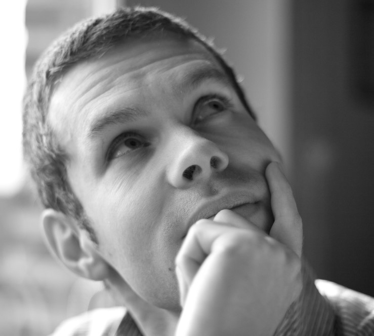 black and white photo of man's head looking pensive