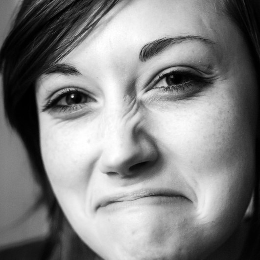 black and white photo of female with a wrinkled nose