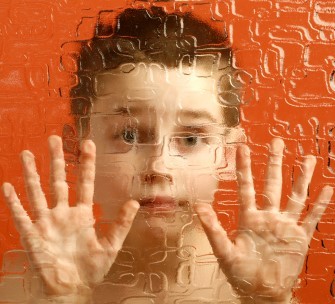 photo of boy behind textured glass