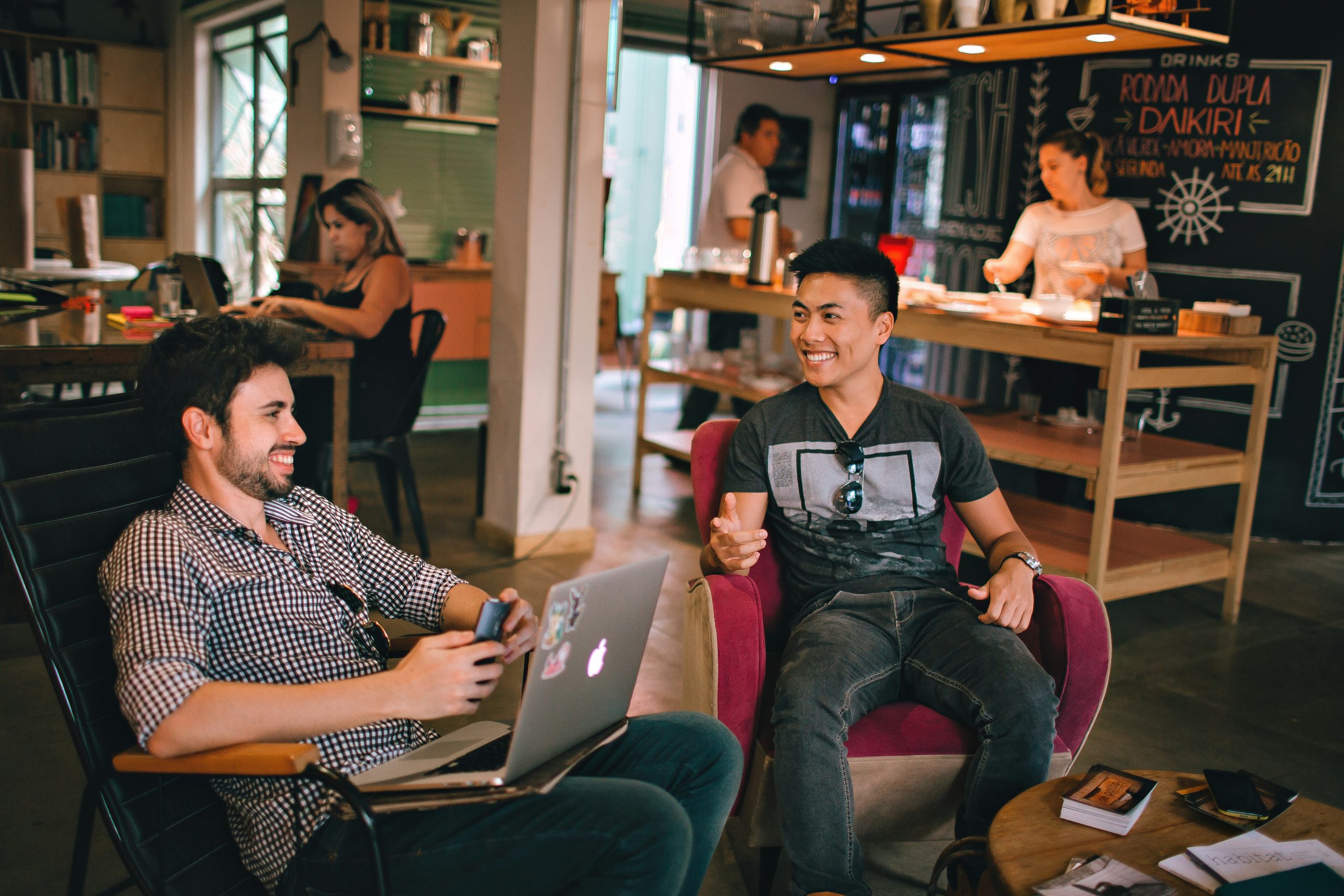 two men sitting and laughing