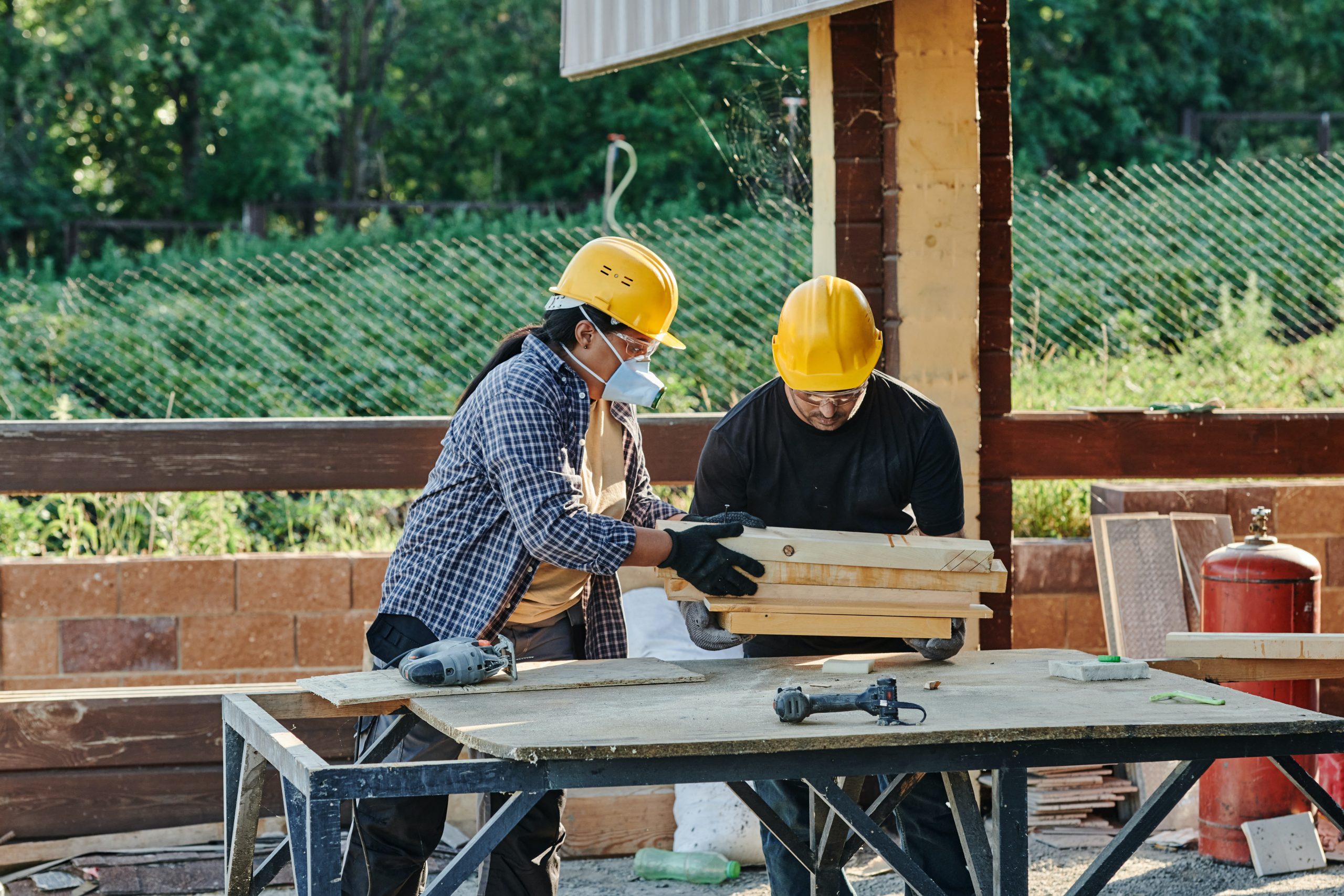 Photo of two people workin on a construction site.