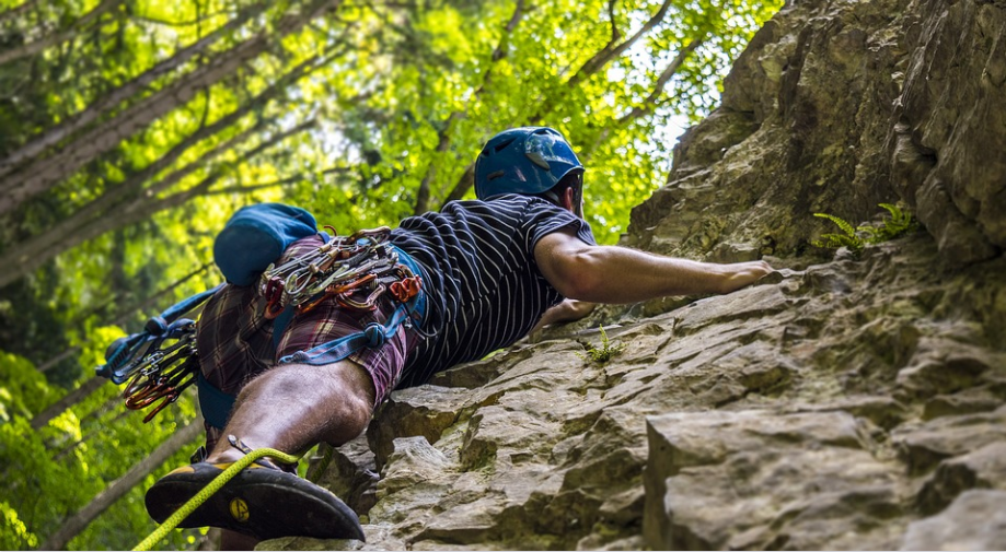 Photo of a person scaling a cliff.