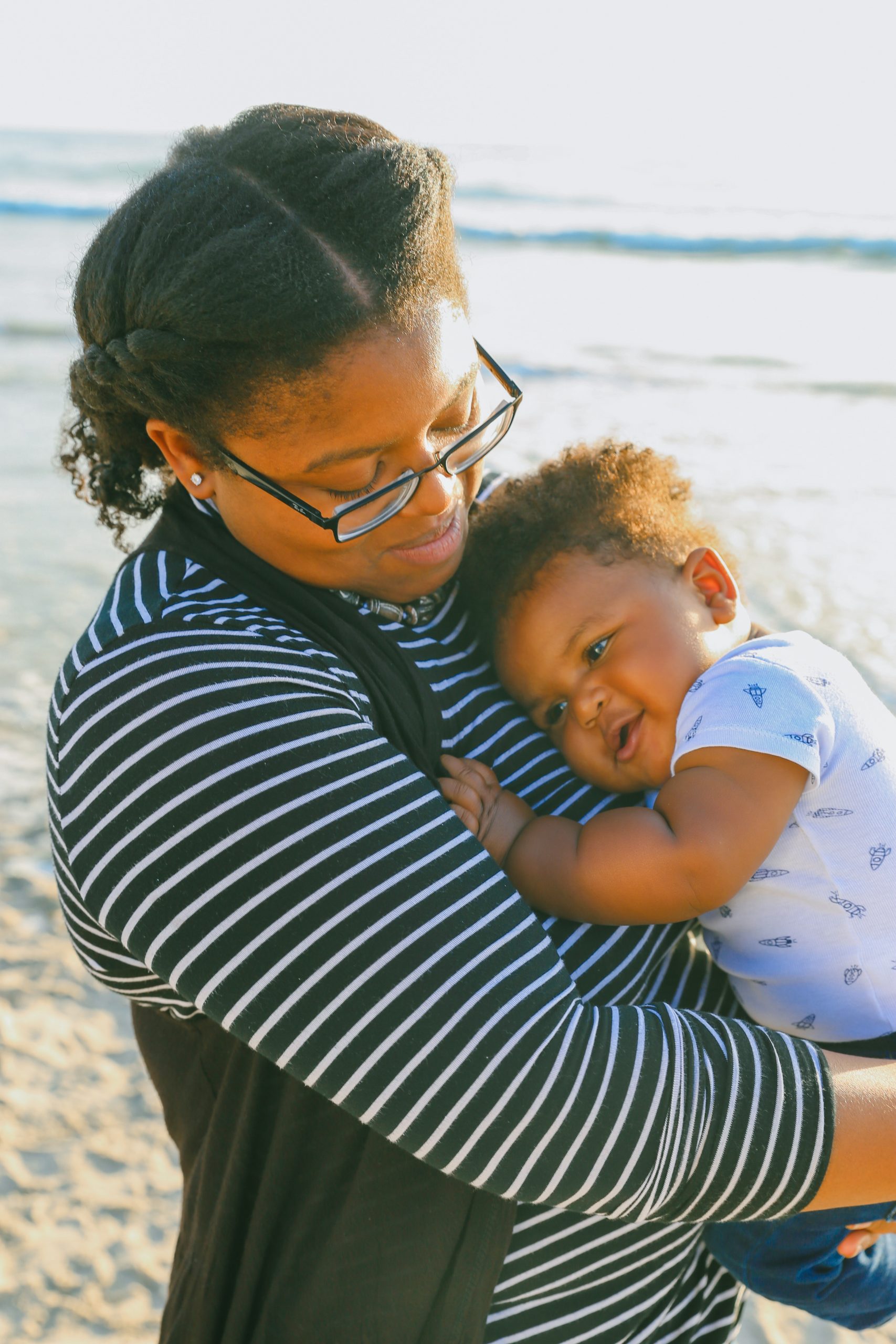 Photo of mother and infant both smiling and embracing