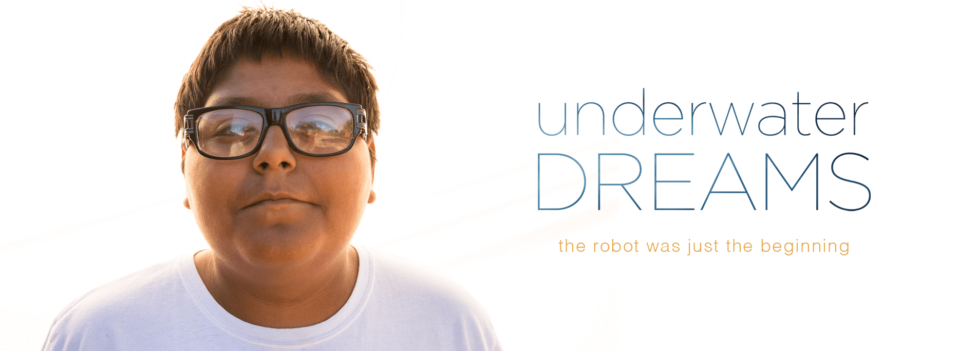 Image of a young boy wearing glasses against a white background with the title "Underwater Dreams: The Robot Was Just the Beginning"