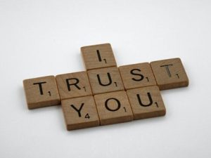 scrabble tiles spelling out 'I trust you'