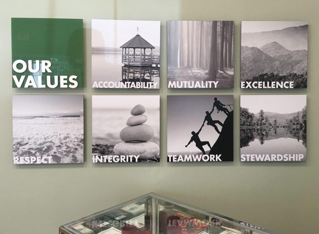 Photo display in bank lobby showing photographs meant to embody concepts like 'integrity' or honesty