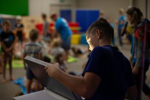 Boy in classroom looking at a tablet.
