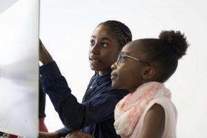 Student and parent interacting with class through web conferencing application.