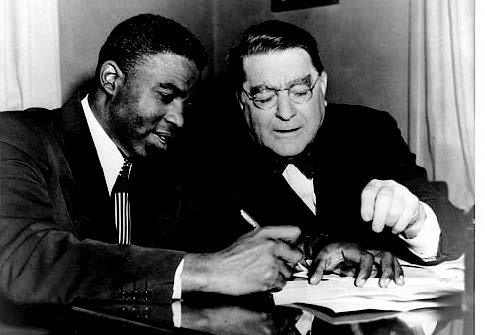 Figure 24.10: Jackie Robinson and Branch Rickey on signing day.