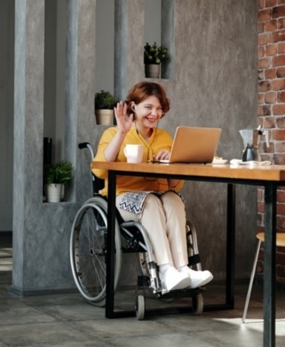 Woman in wheelchair on a video call on a laptop
