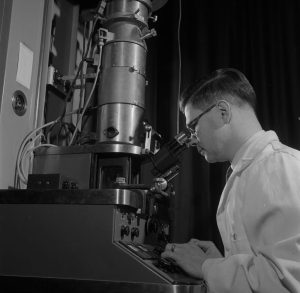A scientist using an electron microscope