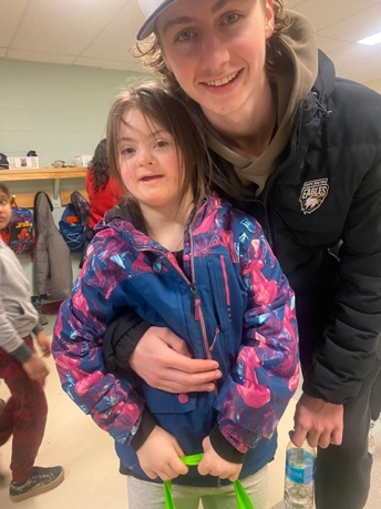 A player from the Cape Breton Eagles with a student.