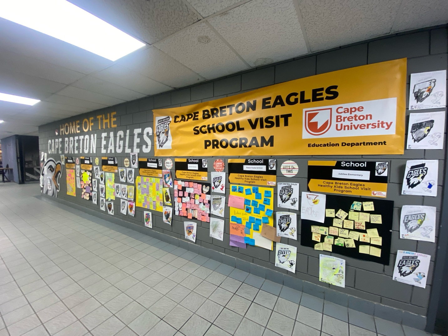 A wall showcasing highlights of the School Visit Program.