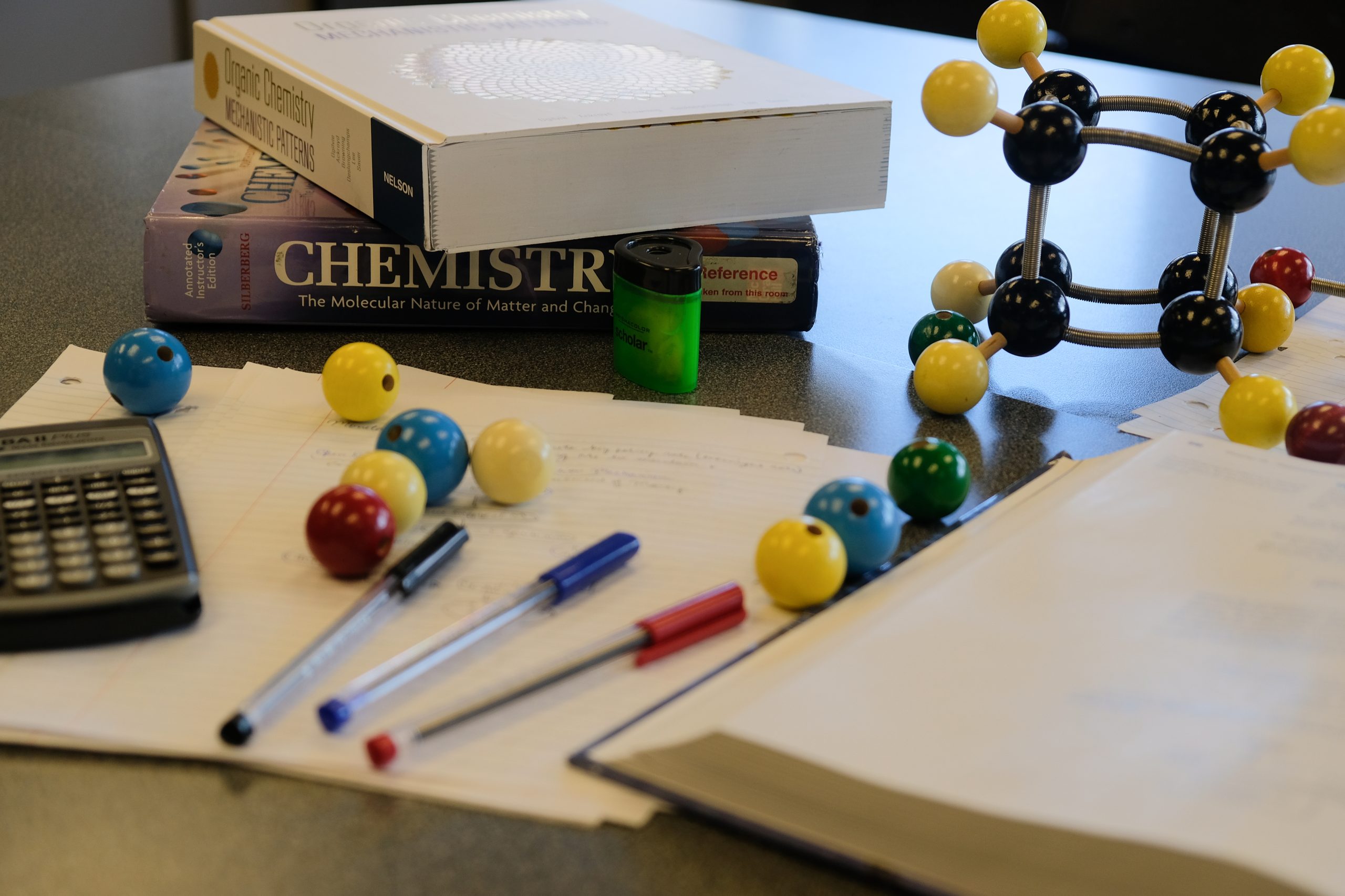 Photo of textbooks, notebooks, pens and learning materials