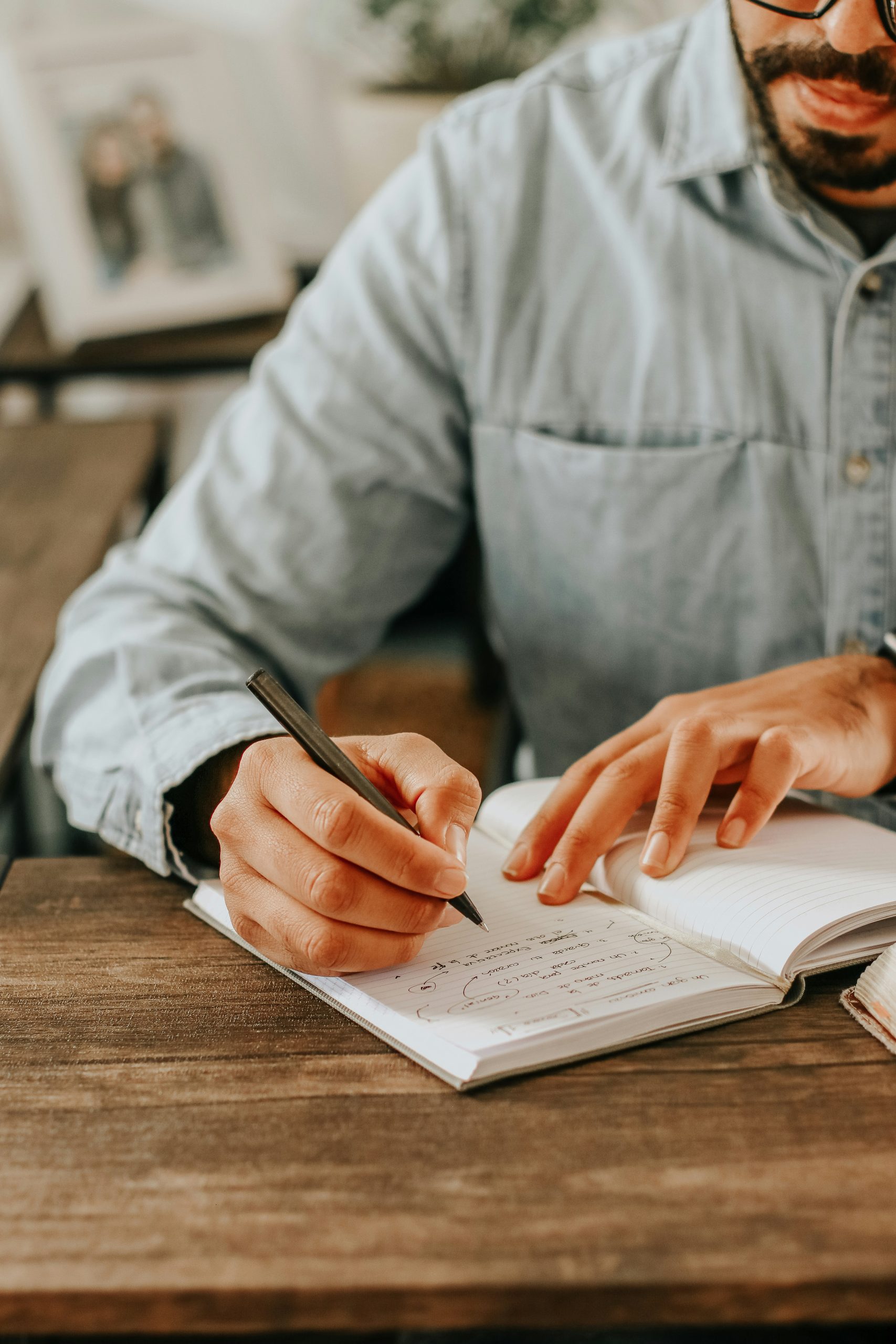 Man Writing in Book
