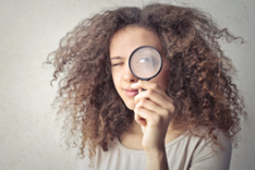 Woman Holding Up a Magnifying Glass