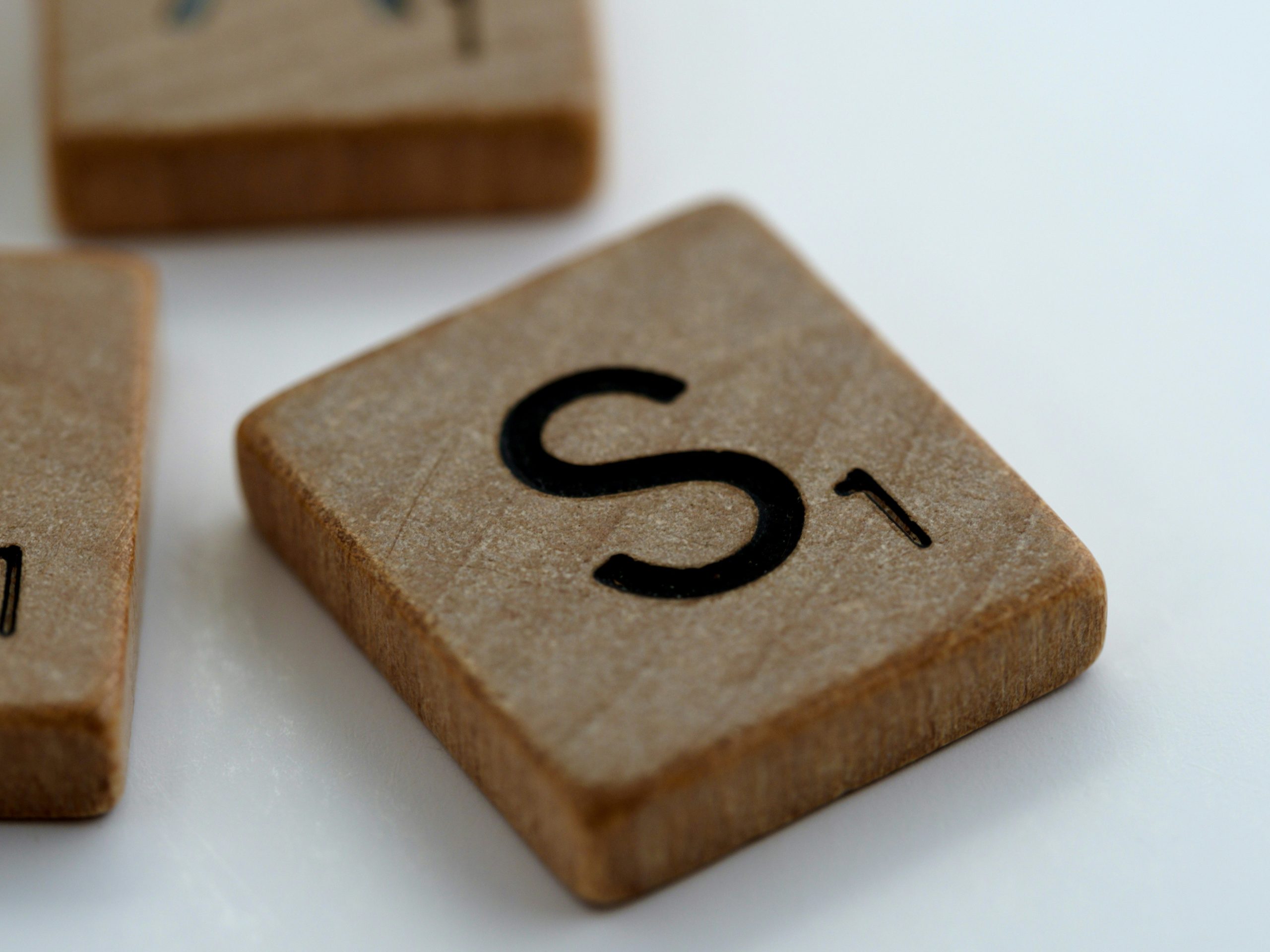 Image shows the letter S on a Scrabble tile