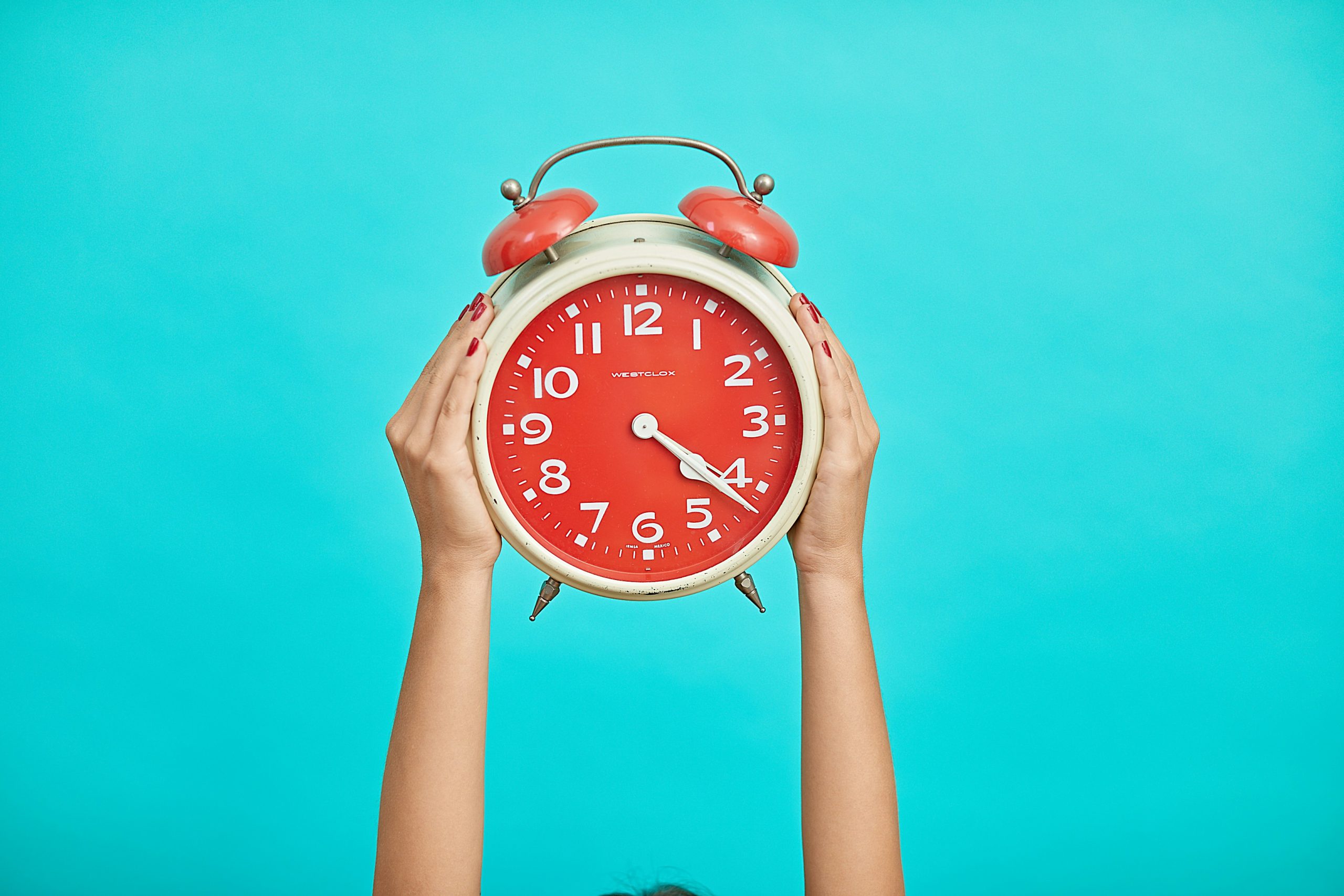 Clock being held up by hands