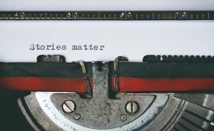 Typewriter page with the words "Stories Matter"