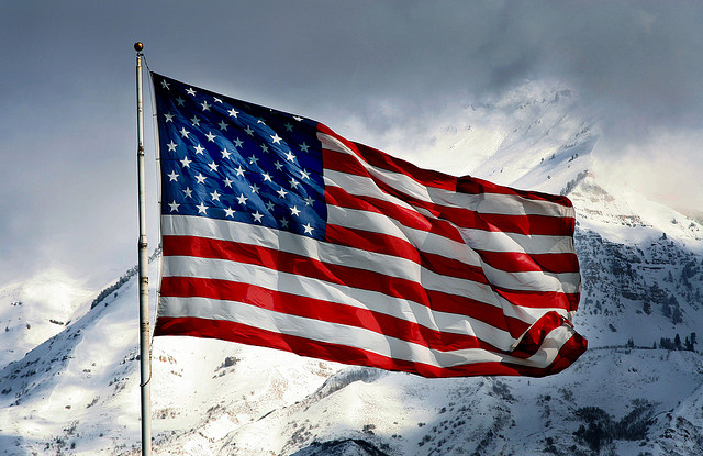 A US flag on a snowy mountain