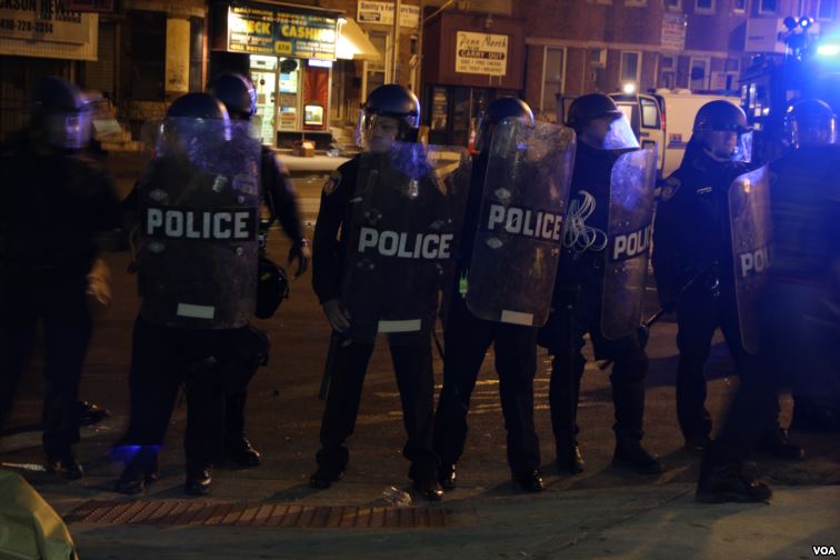 Riot police form a line to push back protesters and media, Baltimore, April 28, 2015. (Victoria Macchi/VOA News)