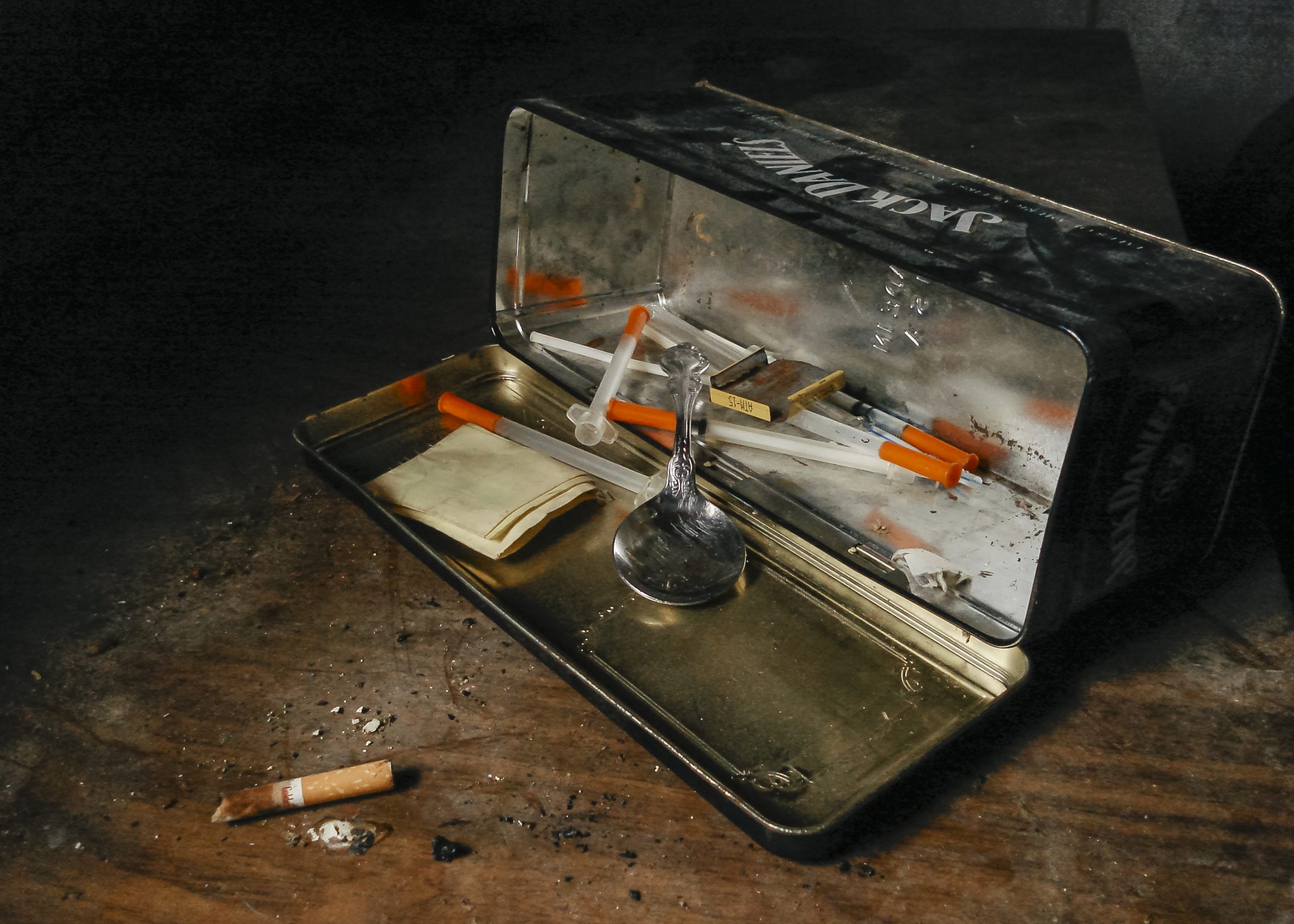 A junkie kit, heroin paraphernalia in a Jack Daniels tin